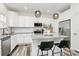 Well-lit kitchen offers granite counters, stainless appliances, a central island, and bar stool seating at 5524 Howard St, Charlotte, NC 28269