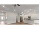 Open kitchen with white cabinets, stainless steel appliances, granite countertops, and hardwood floors at 5613 Skinny Dr, Charlotte, NC 28215