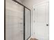 Modern bathroom with glass-enclosed shower, white tile, and chrome fixtures at 5613 Skinny Dr, Charlotte, NC 28215