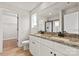 Bathroom featuring a double vanity, granite countertops, and a glass-enclosed shower at 5704 Skinny Dr, Charlotte, NC 28215