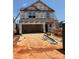 New construction home with a two-car garage and visible framing at 5704 Skinny Dr, Charlotte, NC 28215