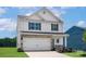 Two-story home featuring stone accents, white siding, a two-car garage and black shutters at 5704 Skinny Dr, Charlotte, NC 28215