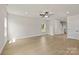 Open concept living area with hardwood floors, natural light, neutral walls, and a ceiling fan at 5704 Skinny Dr, Charlotte, NC 28215