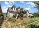 Exterior view of the backyard featuring a screened porch, patio, and beautifully landscaped yard at 615 Vega Nw St, Concord, NC 28027