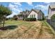Well-maintained backyard with a screened-in porch, lush lawn, and privacy fence for outdoor enjoyment at 615 Vega Nw St, Concord, NC 28027