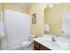 Bright bathroom with a wooden vanity, commode, and a shower featuring a white curtain at 615 Vega Nw St, Concord, NC 28027