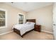 Cozy bedroom with a wood-framed bed, a nightstand, a window, and neutral carpeting at 615 Vega Nw St, Concord, NC 28027