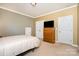 Bedroom featuring a dresser with a television and a bed at 615 Vega Nw St, Concord, NC 28027