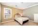 Bedroom with a metal-framed bed, a nightstand, and a window at 615 Vega Nw St, Concord, NC 28027