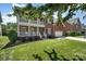 Red brick home boasts a double porch, manicured lawn, and attached two-car garage at 615 Vega Nw St, Concord, NC 28027