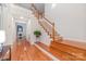 Bright foyer with wooden staircase and floors leading to the main living areas at 615 Vega Nw St, Concord, NC 28027