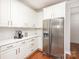 Bright kitchen with stainless steel appliances, white cabinets, and hardwood floors at 615 Vega Nw St, Concord, NC 28027