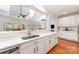 Spacious kitchen with stainless steel sink, quartz countertops, wooden floors, and a bright view at 615 Vega Nw St, Concord, NC 28027