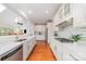 Bright kitchen with stainless steel appliances, quartz countertops, wooden floors, and open to living space at 615 Vega Nw St, Concord, NC 28027