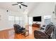 Cozy living room features hardwood floors, vaulted ceilings and a large window for natural light at 615 Vega Nw St, Concord, NC 28027