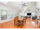 Bright living room featuring hardwood floors, skylights, ceiling fans, and large windows at 615 Vega Nw St, Concord, NC 28027