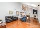 Open-concept living room with hardwood floors, high ceilings, ceiling fans, and a fireplace at 615 Vega Nw St, Concord, NC 28027