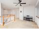 Open living space featuring neutral walls, a ceiling fan, and a charming banister overlooking the floor below at 615 Vega Nw St, Concord, NC 28027