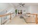 Open loft area with neutral walls, fan, wood railing and view of game room at 615 Vega Nw St, Concord, NC 28027