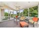 Relaxing screened porch with comfortable seating, ceiling fan, and beautiful backyard views at 615 Vega Nw St, Concord, NC 28027