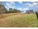 Wide view of the fenced in backyard with a home in the distance at 619 N Skyland Dr, Mount Pleasant, NC 28124