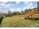 Large backyard featuring a wooden fence and a small building in the distance at 619 N Skyland Dr, Mount Pleasant, NC 28124