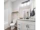 Cozy bathroom featuring a granite countertop, modern vanity, and updated lighting at 619 N Skyland Dr, Mount Pleasant, NC 28124