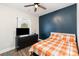 Cozy bedroom featuring a stylish accent wall, ceiling fan, and a large window with natural light at 619 N Skyland Dr, Mount Pleasant, NC 28124