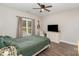 Comfortable bedroom with a ceiling fan, a guitar, and a window with natural light at 619 N Skyland Dr, Mount Pleasant, NC 28124