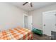 Bright bedroom with a patterned comforter, ceiling fan, and easy access to the hallway at 619 N Skyland Dr, Mount Pleasant, NC 28124