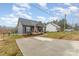 Exterior view of a quaint home showcasing a long driveway and well-maintained front yard at 619 N Skyland Dr, Mount Pleasant, NC 28124