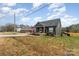 Nice home with an American flag displayed on the front porch and a well-manicured lawn at 619 N Skyland Dr, Mount Pleasant, NC 28124