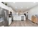 Open concept kitchen with stainless steel appliances, modern white cabinetry, and views of the living area at 619 N Skyland Dr, Mount Pleasant, NC 28124