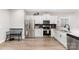 Modern kitchen featuring stainless steel appliances, granite countertops, and sleek white cabinetry at 619 N Skyland Dr, Mount Pleasant, NC 28124