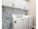 Laundry room featuring a modern washer and dryer with decorative wallpaper at 619 N Skyland Dr, Mount Pleasant, NC 28124