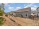 Lush backyard view showcasing the home's manicured lawn, patio area, and tasteful landscaping at 6419 Cambridge Dr, Harrisburg, NC 28075