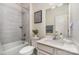 Bright bathroom with tiled shower and tub combination, modern vanity, and decorative accents at 6419 Cambridge Dr, Harrisburg, NC 28075