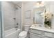 Bright bathroom featuring a bathtub with shower and a decorative floral arrangement at 6419 Cambridge Dr, Harrisburg, NC 28075