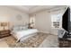 Bright bedroom boasts a decorative rug and a beautifully coordinated bed set at 6419 Cambridge Dr, Harrisburg, NC 28075