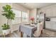 The dining area features a decorative plant near the window and a dining table set with flowers and elegant chairs at 6419 Cambridge Dr, Harrisburg, NC 28075