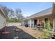 Spacious backyard featuring a concrete patio, garden beds, and a well-maintained lawn at 7909 Parknoll Dr, Huntersville, NC 28078