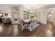 An open dining room showcases wood floors, modern lighting, and access to the living room at 7909 Parknoll Dr, Huntersville, NC 28078