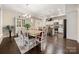 Open dining room features modern lighting, hardwood floors, and access to the kitchen at 7909 Parknoll Dr, Huntersville, NC 28078