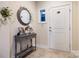 Warm and inviting foyer with a decorative table, mirror, and tiled flooring at 7909 Parknoll Dr, Huntersville, NC 28078