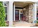 Inviting front porch with a stone facade, bench, and an ADT security system sign for added peace of mind at 7909 Parknoll Dr, Huntersville, NC 28078