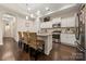 This modern kitchen has an island with bar seating, and stainless-steel appliances at 7909 Parknoll Dr, Huntersville, NC 28078