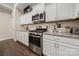 Modern kitchen with stainless steel appliances, stone countertops, and custom white cabinets at 7909 Parknoll Dr, Huntersville, NC 28078