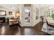 Bright living room showcasing wood floors, fireplace, furniture, and sliding glass door to the patio at 7909 Parknoll Dr, Huntersville, NC 28078