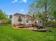 Spacious backyard featuring a deck, patio with a firepit, and well-maintained landscaping, ideal for entertaining at 9009 Stourbridge Dr, Huntersville, NC 28078