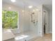 Modern bathroom with glass walk-in shower, a large window, and contemporary fixtures at 9009 Stourbridge Dr, Huntersville, NC 28078